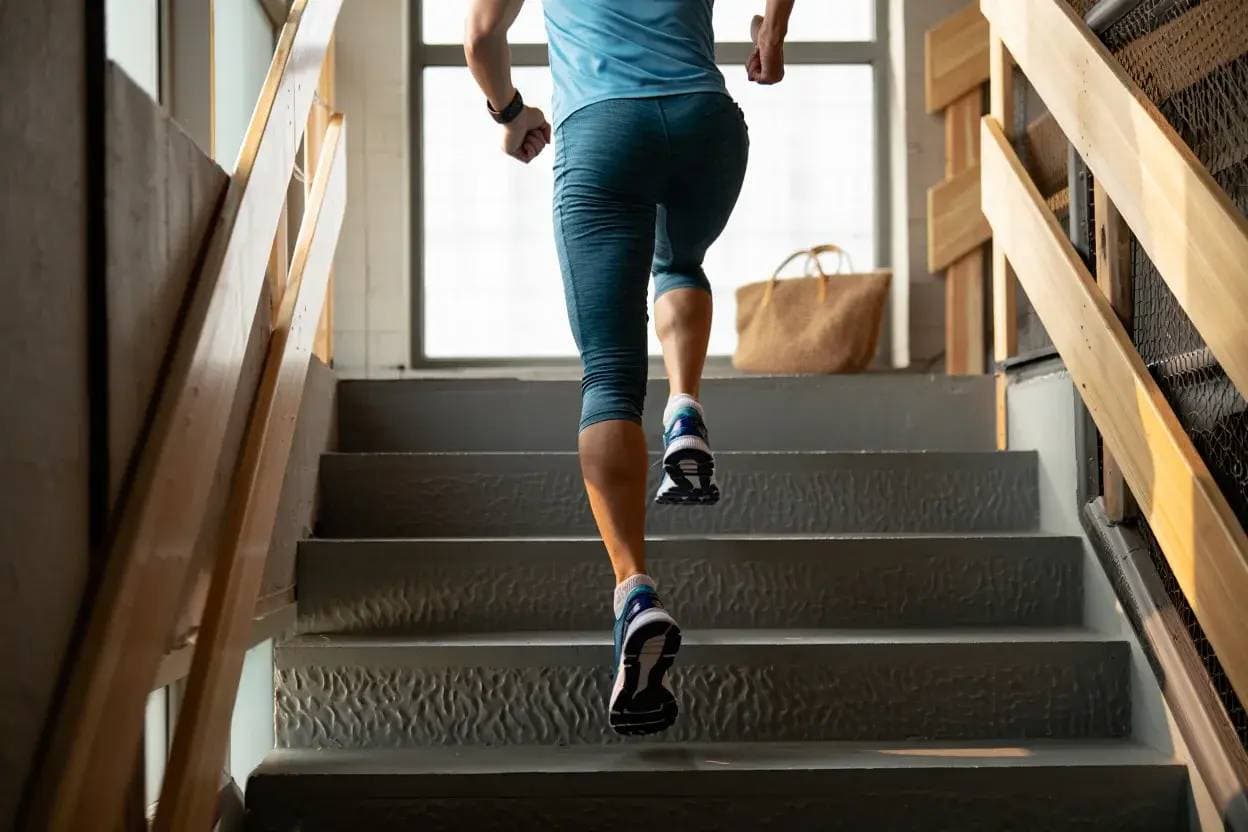 A person staying healthy by running upstairs